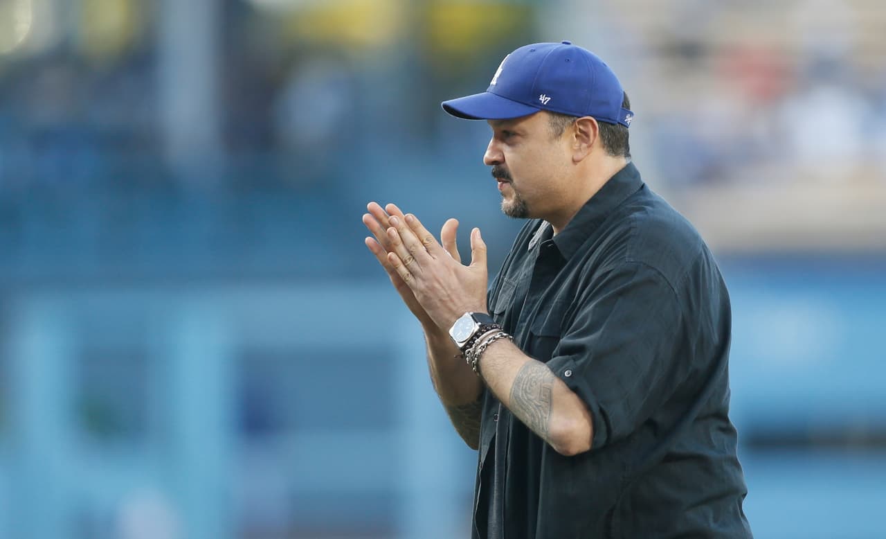 Grammy award winning singer Pepe Aguilar reacts prior to throwing out a ceremonial first pitch before the baseball game between the Los Angeles Dodgers and Washington Nationals at Dodger Stadium, Monday, Aug. 10, 2015, in Los Angeles. (AP Photo/Danny Moloshok)