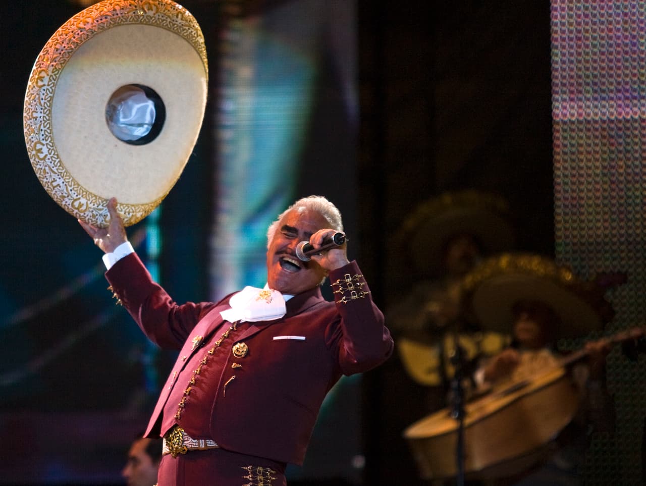 FILE - In this Feb. 14, 2009, file photo, singer Vicente Fernandez performs at a free concert during Valentine's Day in Mexico City's Zocalo. On Tuesday, Oct. 8, 2016 Fernandez received a Gold and Platinum disc for the sales of more than 90,000 copies of his live CD and DVD “Un Azteca en el Azteca” in Mexico. The album was recorded at the farewell concert of Fernandez at the Azteca Stadium in April, 2016. (AP Photo/Claudio Cruz, File)