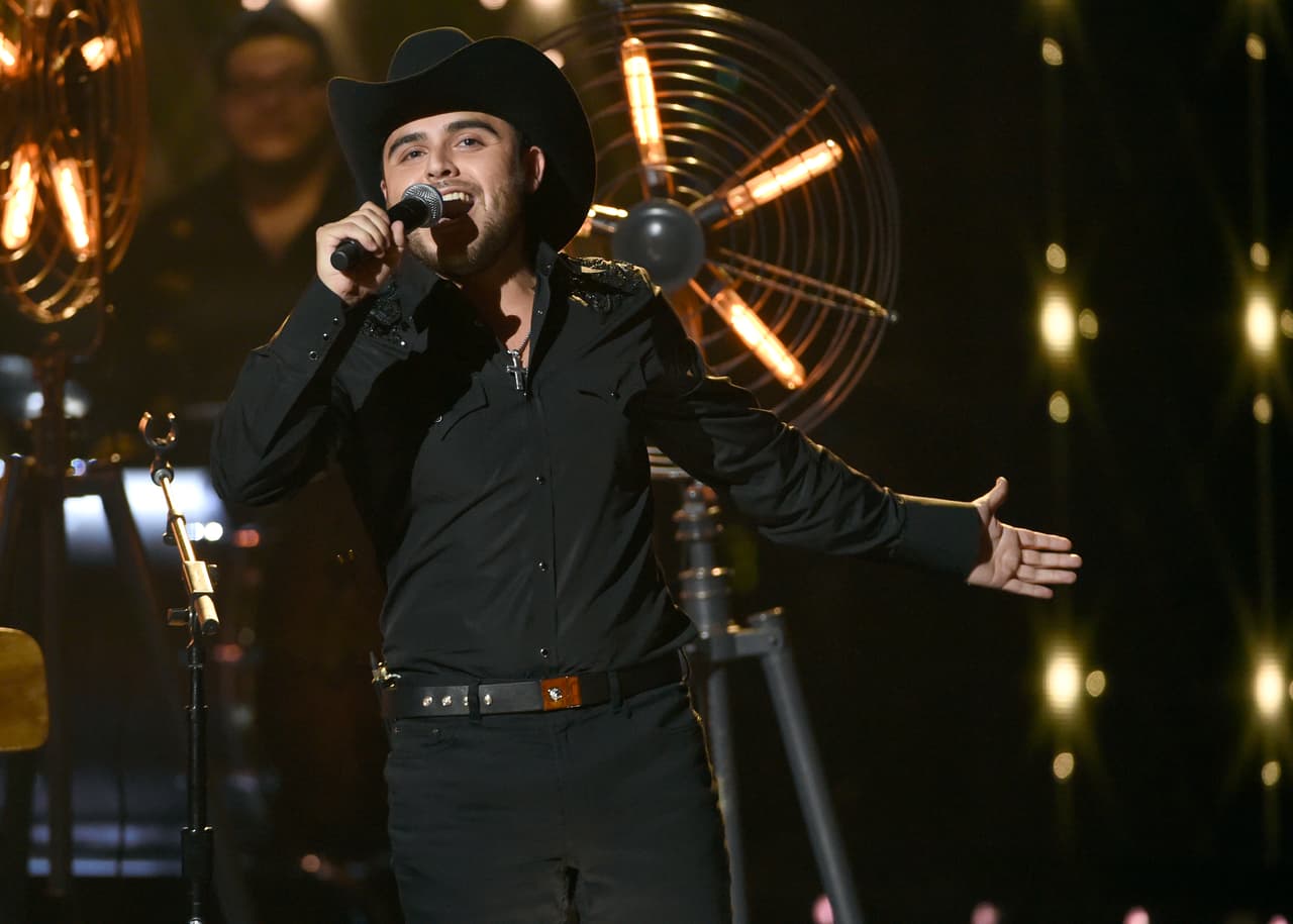 FILE - In this Oct. 8, 2015 file photo, Gerardo Ortiz y su Banda performs at the Latin American Music Awards at the Dolby Theatre in Los Angeles. Ortiz will premiere in January 2016 his movie "Como un sueno" on Telemundo and debut the reality show "Gerardo Ortiz: Sin Censura." Both projects portray him and his career. (Photo by Chris Pizzello/Invision/AP, File)