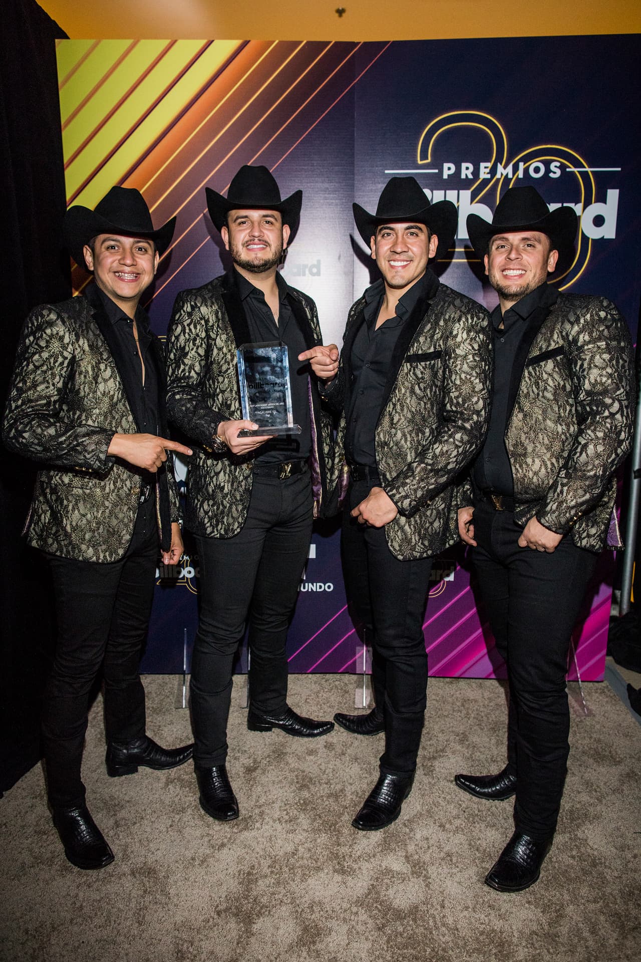 Calibre 50 poses with the award for hot Latin songs artist of the year, duo or group, at the Latin Billboard Awards at Mandalay Bay Events Center on Thursday, April 26, 2018, in Las Vegas. (Photo by Joe Buglewicz/Invision/AP)